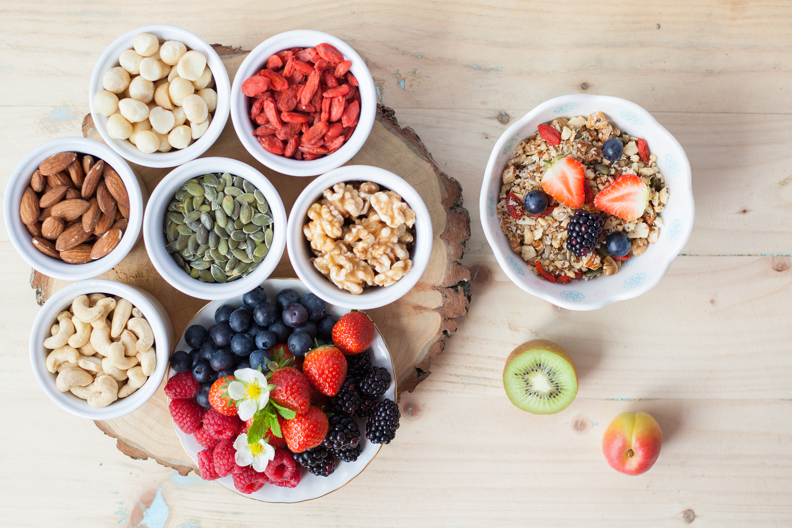 Paleo style breakfast gluten free grain free oat free granola with mixed nuts and fresh berries and fruits selective focus top view
