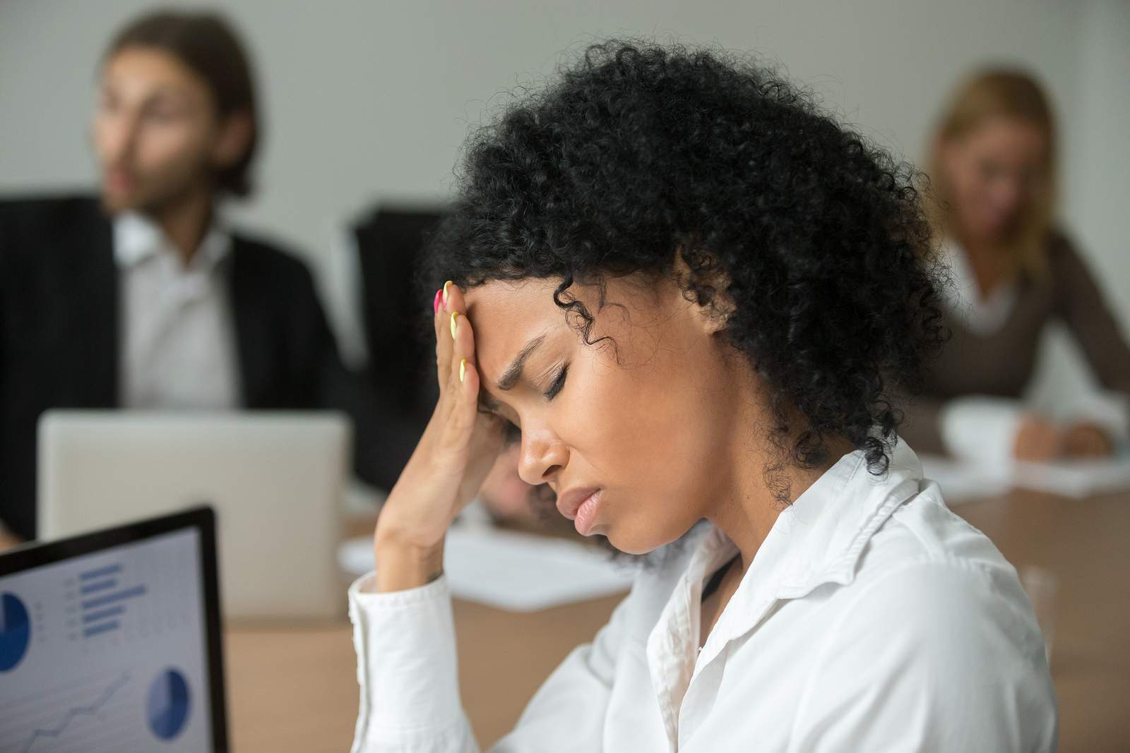 African american businesswoman feeling unwell suffering from headache migraine touching forehead at team meeting upset black woman employee frustrated by business problem or work stress head shot